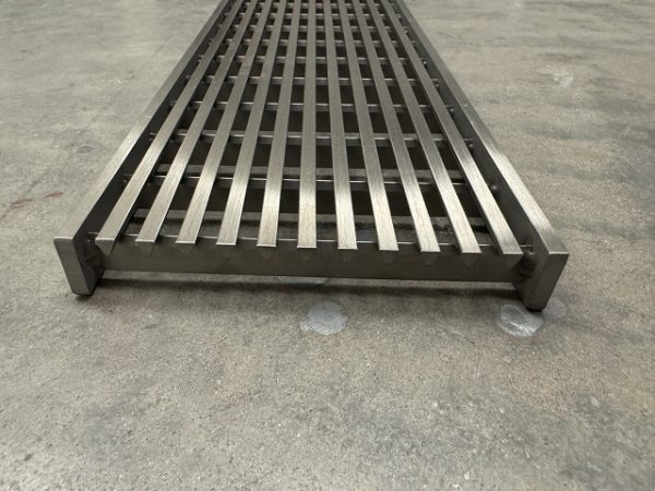 Stainless steel linear grate passing car